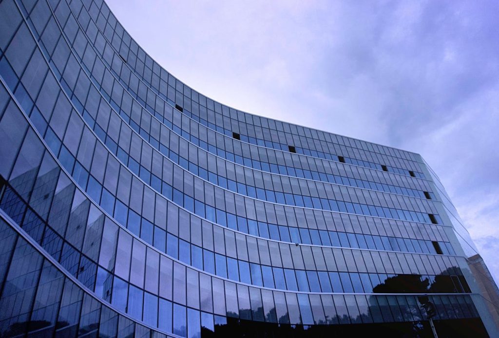 Contemporary glass building in Tiranë, showcasing modern urban architecture.